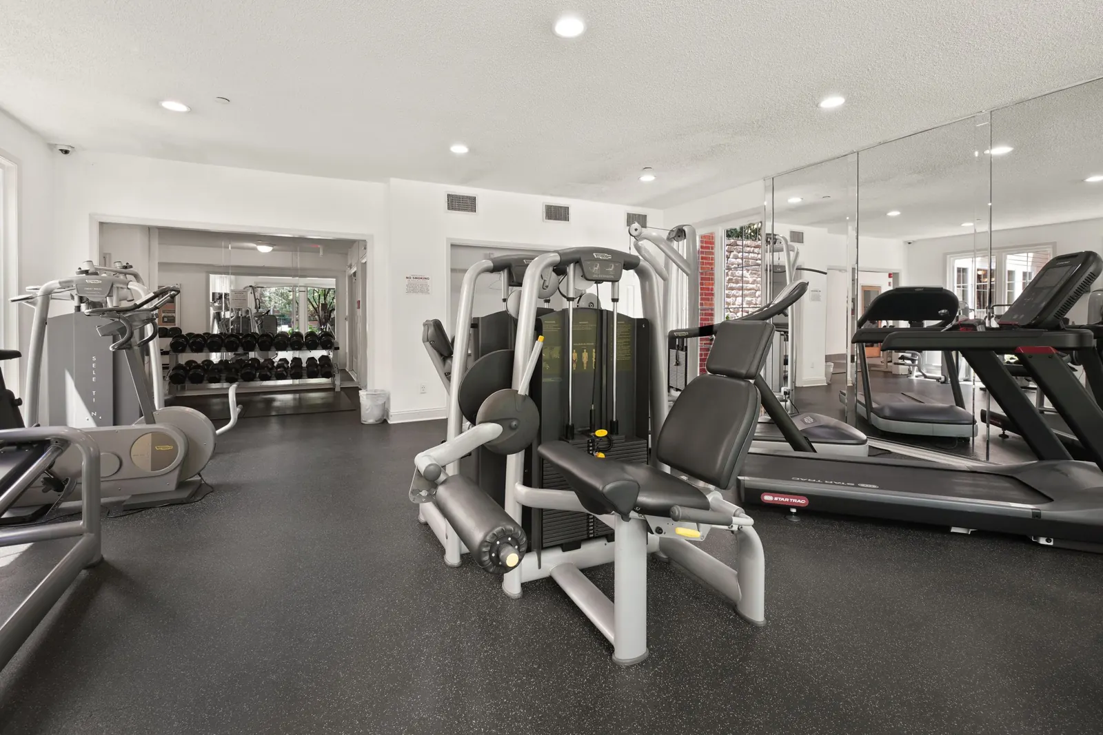An empty gym floor with equipment